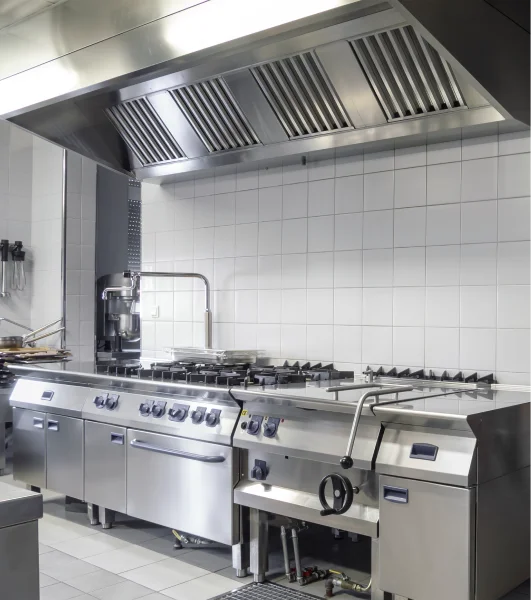 A commercial kitchen with stainless steel appliances.