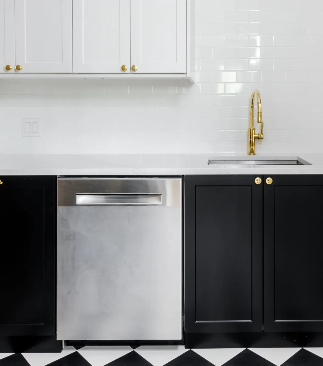 A black and white kitchen with a checkered floor.